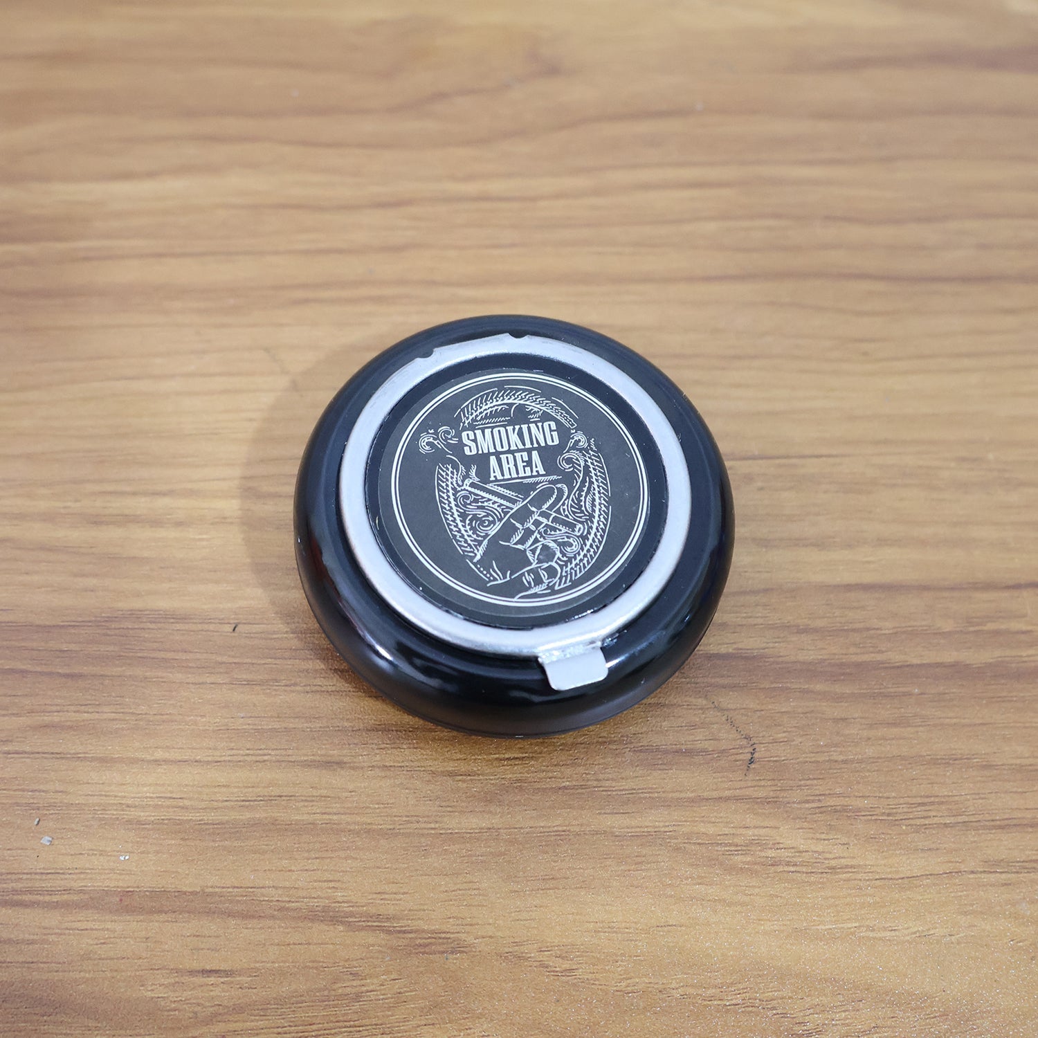 Ashtray placed on table showcasing windproof smoke control lid
