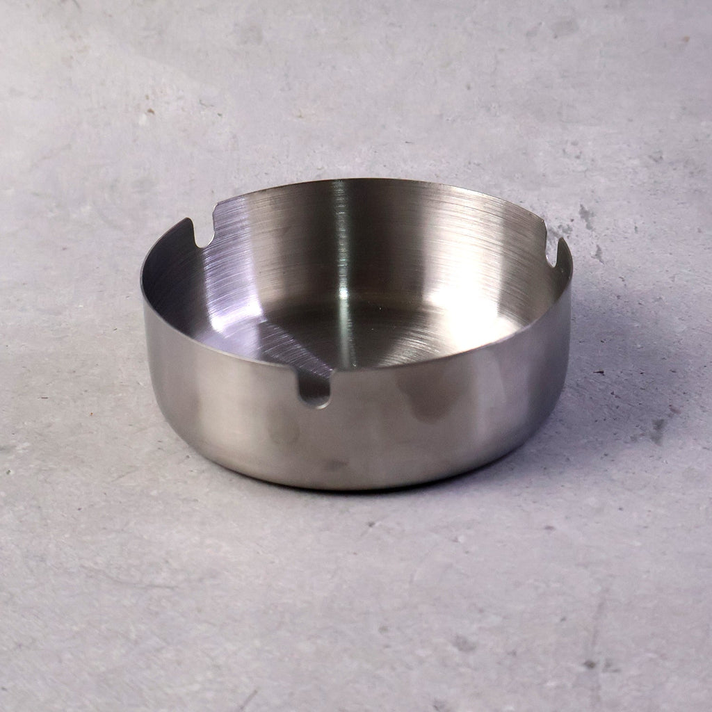 Stable tabletop ashtray with multiple slots for cigarette rests