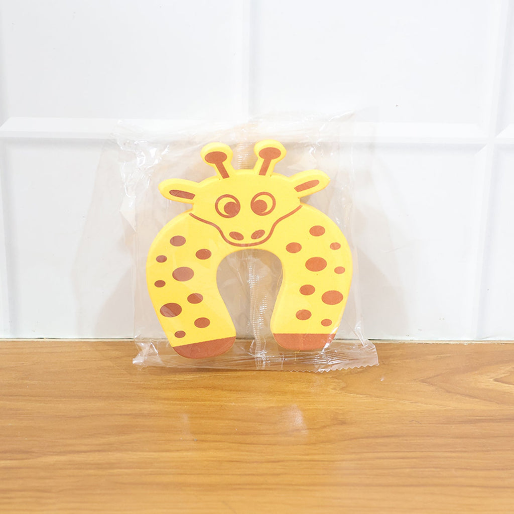 Close-up of the door stopper securely placed under a door on the floor.