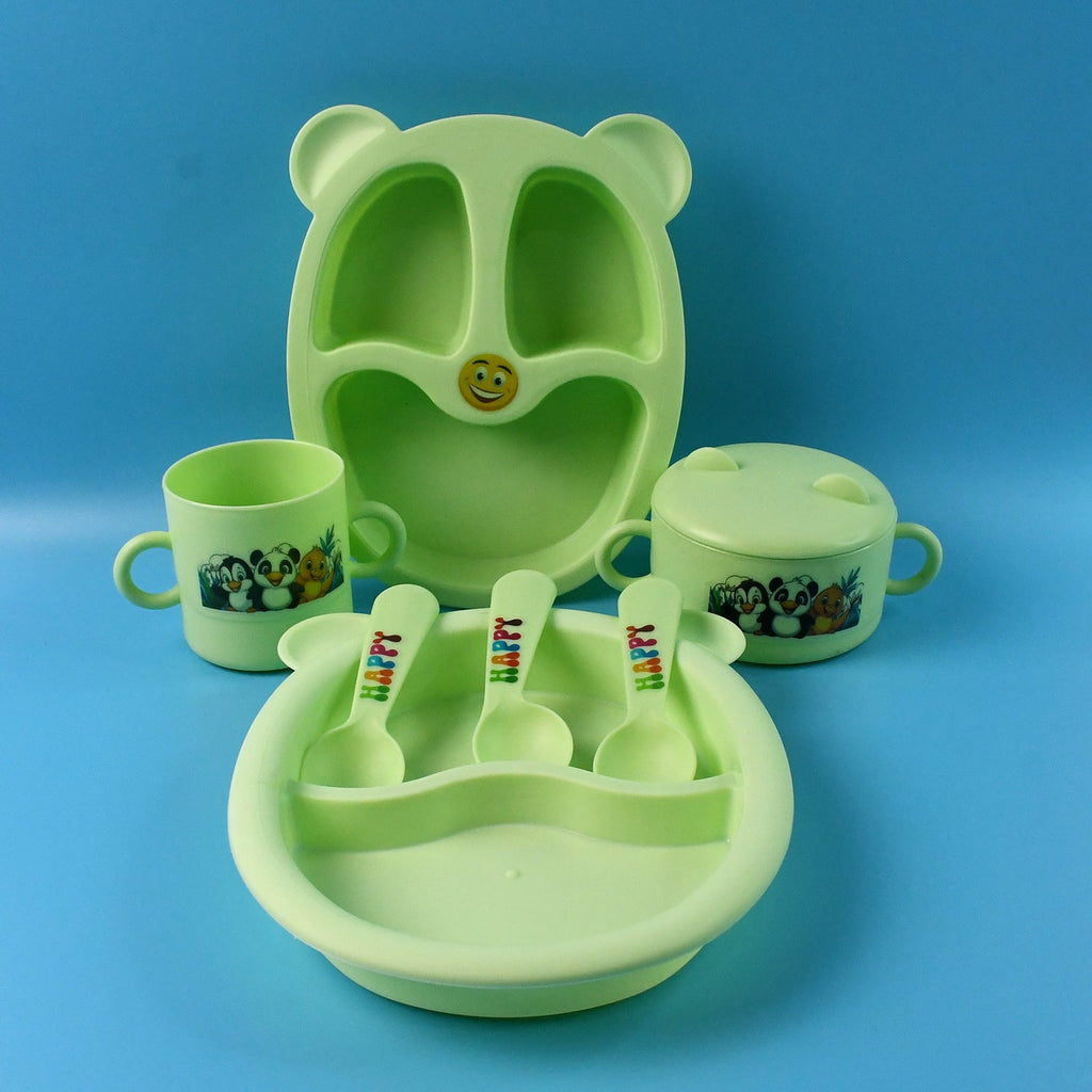 Kids feeding dinner set pieces arranged showing spoon, mug, bowl and plates