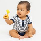 Close-up of infant holding star-shaped baby rattle toy for sensory development