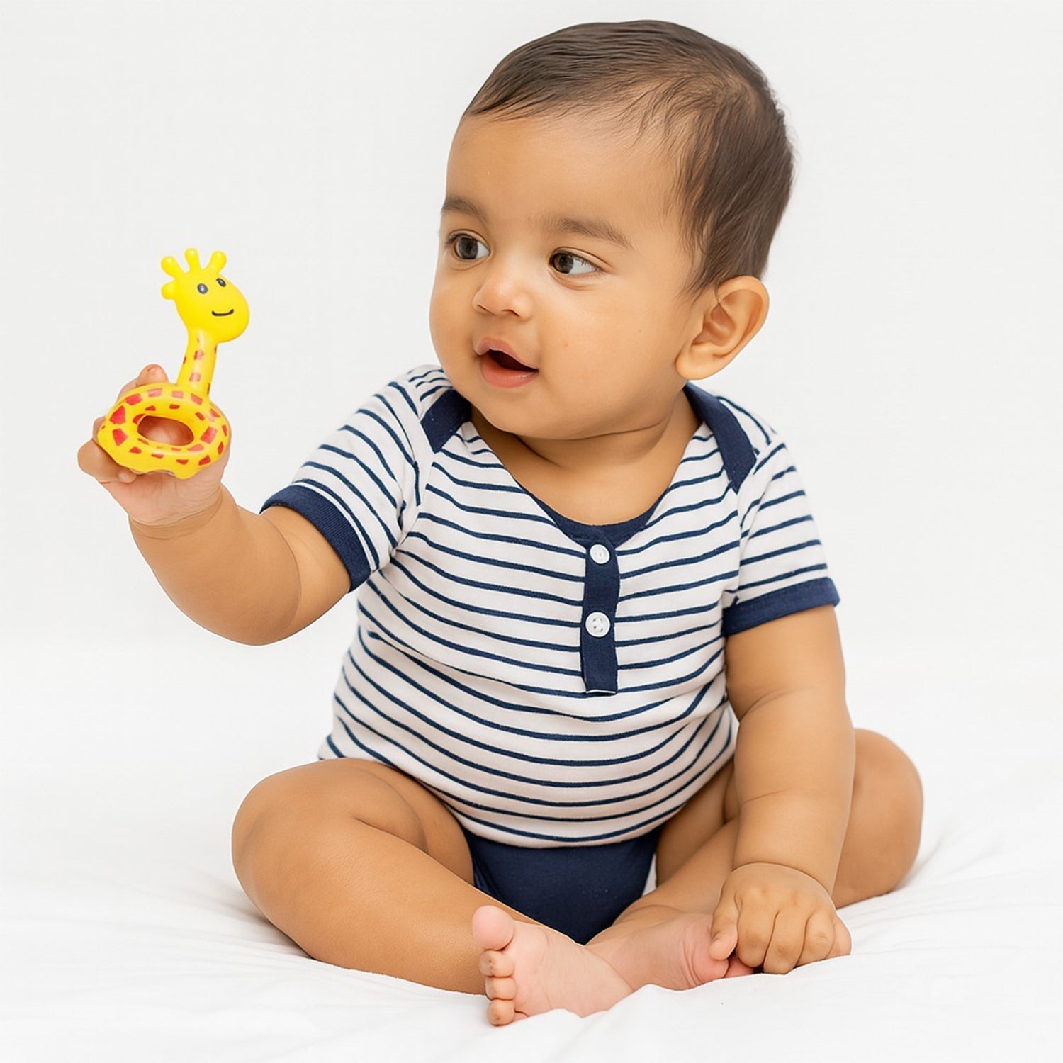 Close-up of infant holding star-shaped baby rattle toy for sensory development