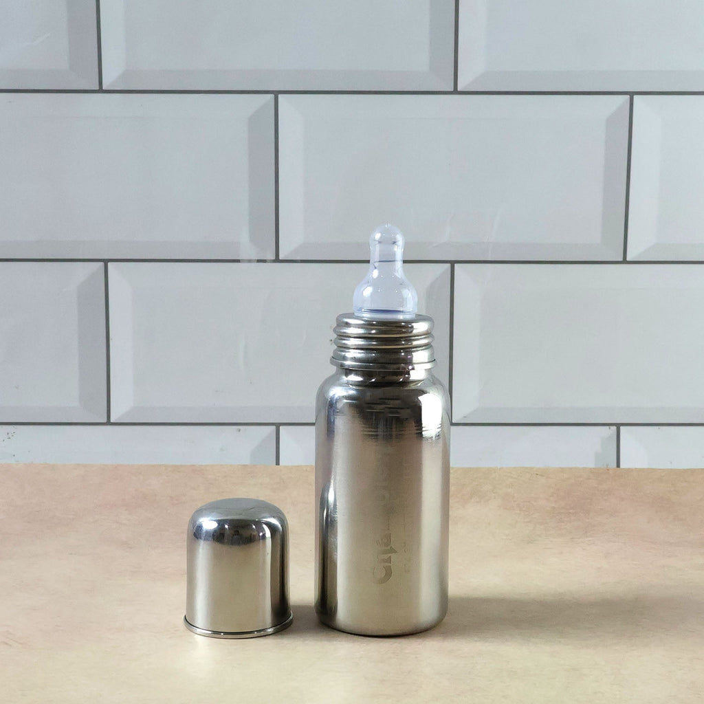 Soft silicone nipple on a stainless steel infant milk bottle