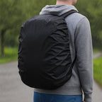 Rain cover effectively protecting a laptop bag from heavy rain, showcasing its waterproof design.