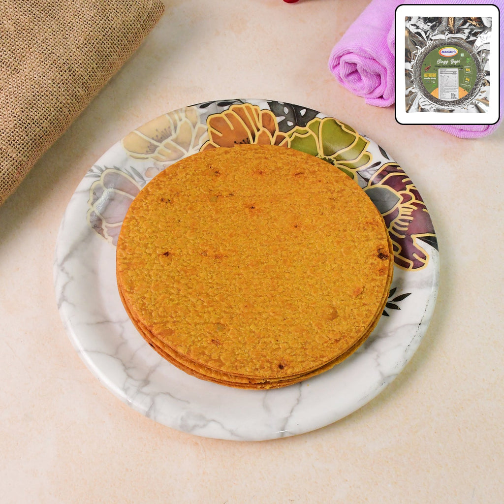 Crispy Maniarr's Bajri Khakhra with ginger garlic flavor on a white plate, golden texture visible.