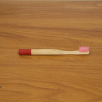 Lifestyle image of bamboo toothbrush in bathroom setting