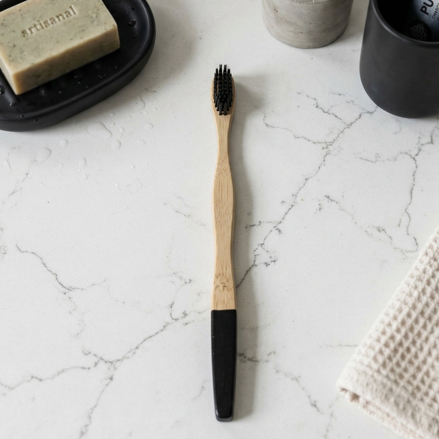 Bamboo toothbrush angled view showing charcoal-infused bristles