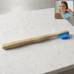 Sustainable wooden toothbrush with soft blue bristles and natural handle