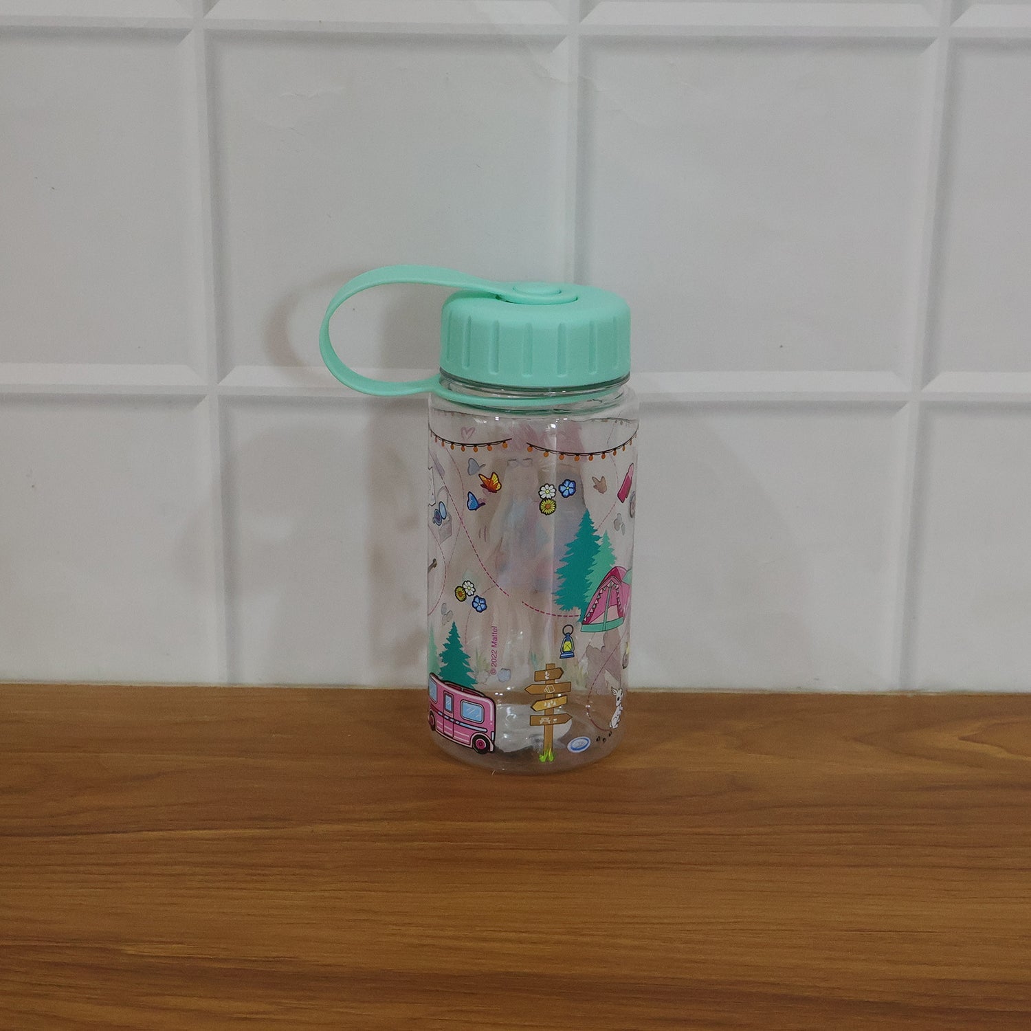Child carrying a water bottle with strap