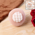 Soft exfoliating round bath scrubber with foam grip creating rich lather