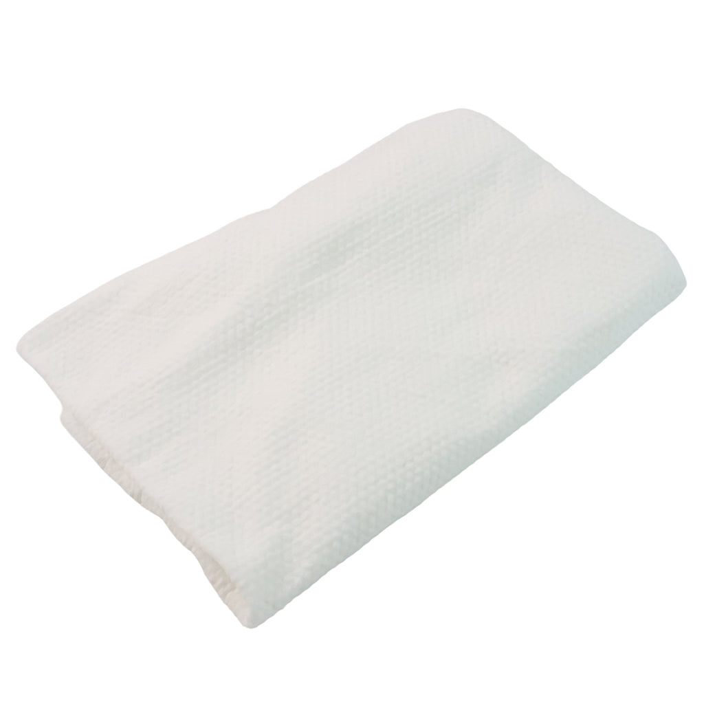 Compact bath towel folded into a small puck for travel