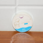 Compressed travel towel in its single-use hygienic pack