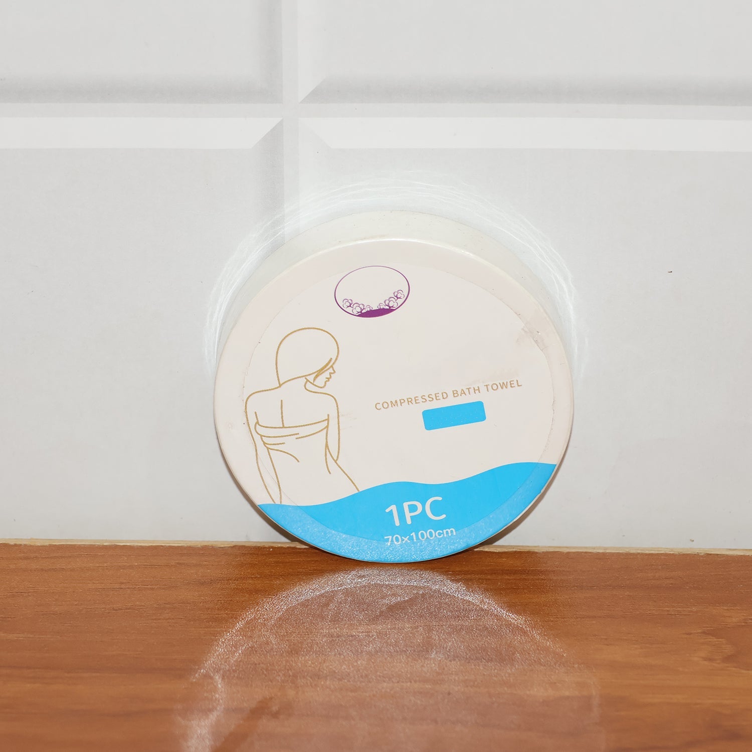 Compressed travel towel in its single-use hygienic pack