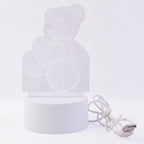 Teddy bear LED Night Lamp glowing softly in dark room