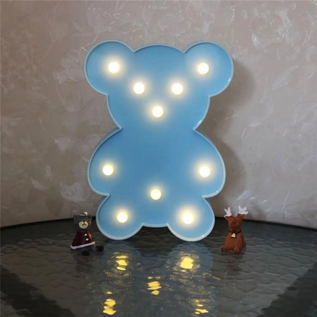Battery operated teddy bear LED night light placed on table as kids room decor