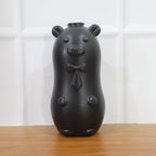 Bear shaped toilet tank cleaner in use inside toilet flush tank