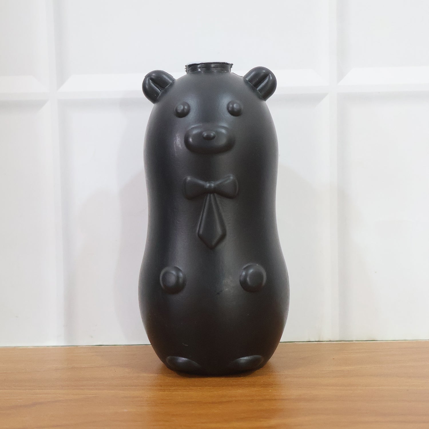 Bear shaped toilet tank cleaner in use inside toilet flush tank