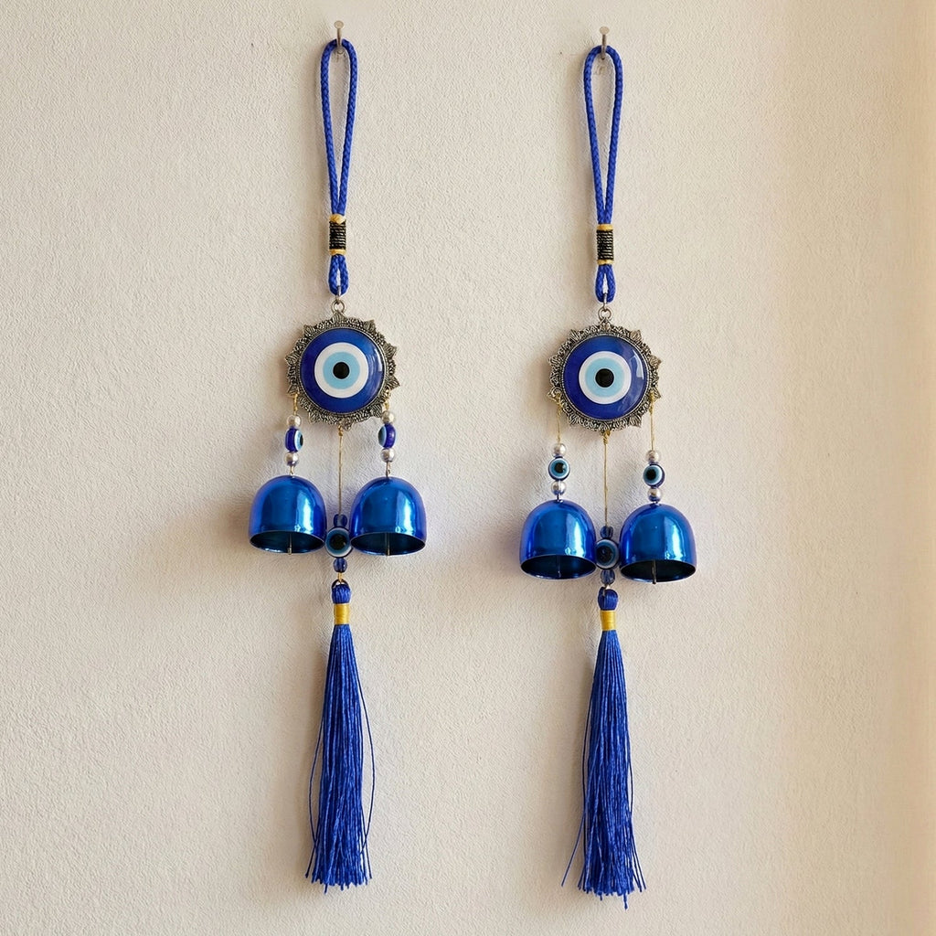 Close-up of hanging wind chime with evil eye charm and decorative tassels