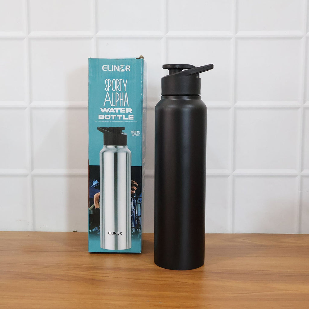 Black stainless steel sports water bottle held during outdoor activity