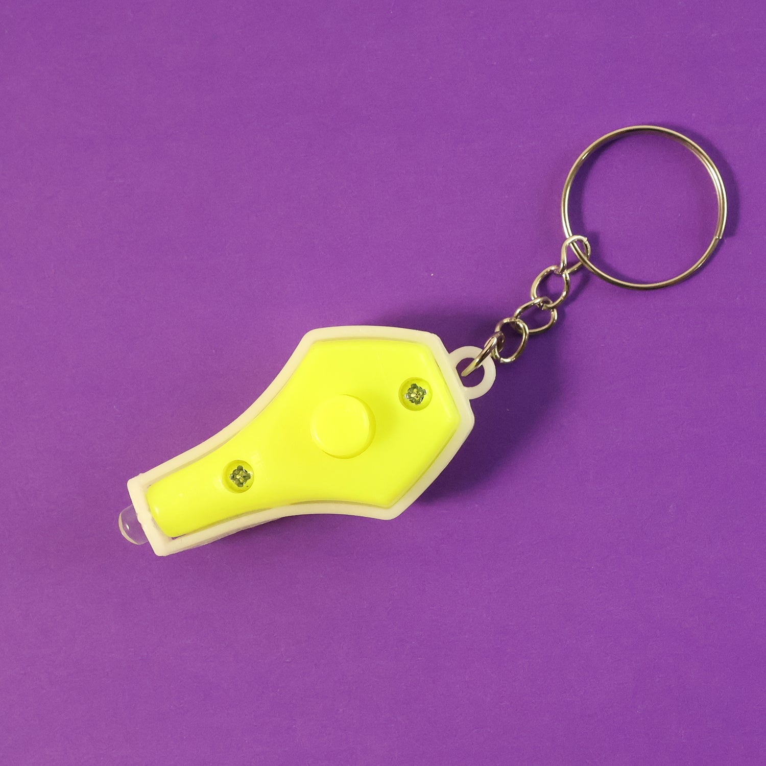 Mini LED keychain flashlight emitting blue UV light, showing portability