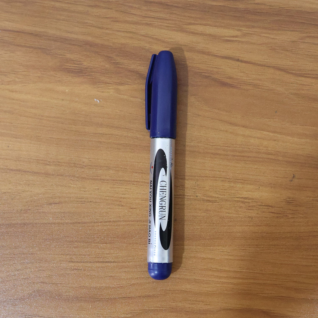Marker pen writing with bold blue ink on smooth surface