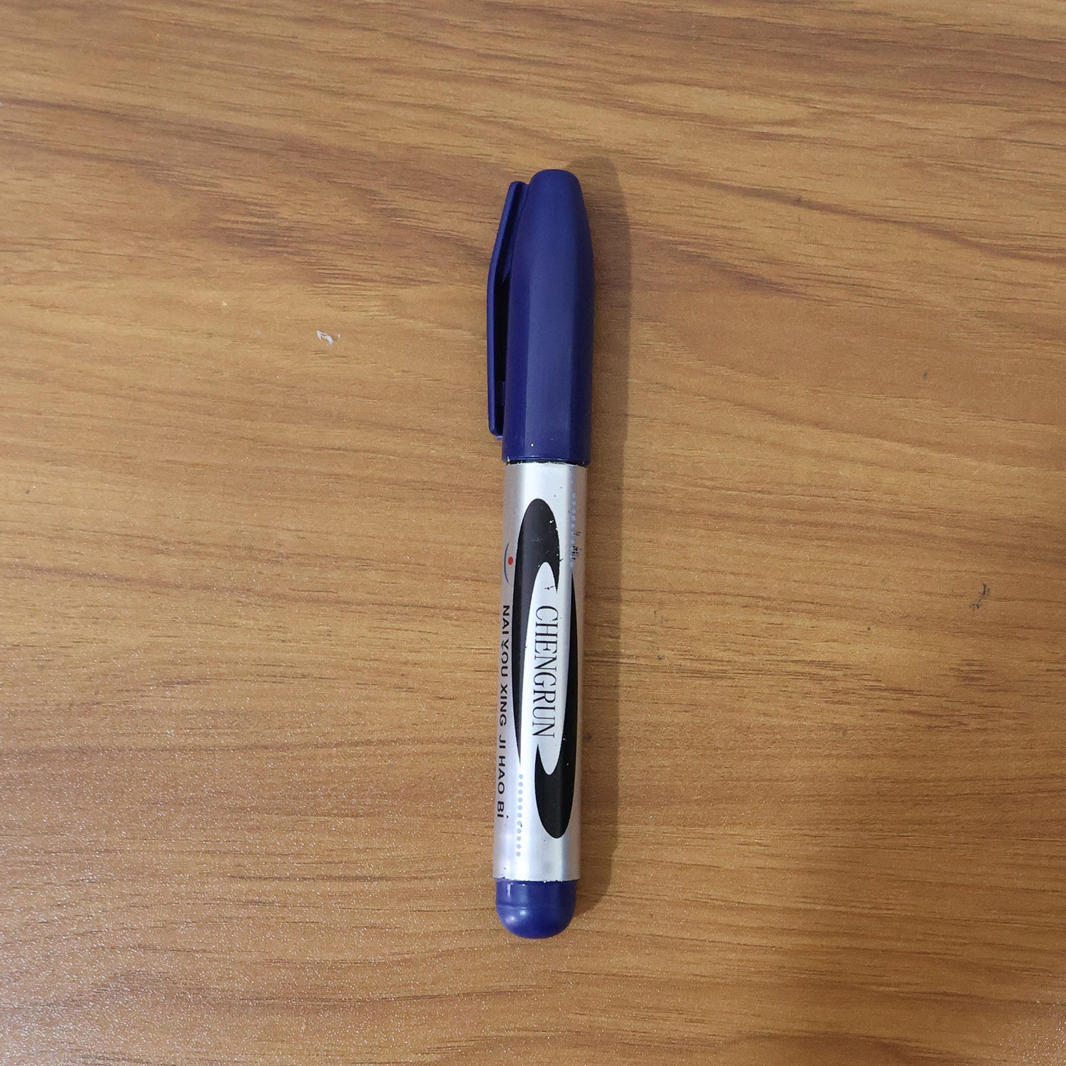Marker pen writing with bold blue ink on smooth surface