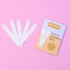 Body & clothing tape kit components arranged, showing tape roll and accessories