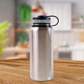 Silver stainless steel vacuum insulated water bottle with double wall keeping drinks hot or cold