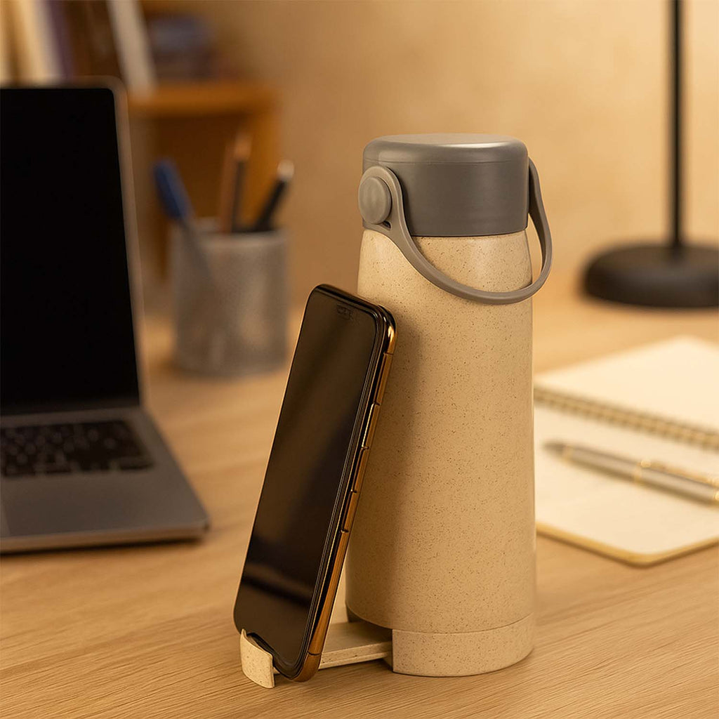 Close-up of the creative glass water bottle, highlighting the convenient phone holder feature.