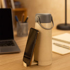 Close-up of the creative glass water bottle, highlighting the convenient phone holder feature.