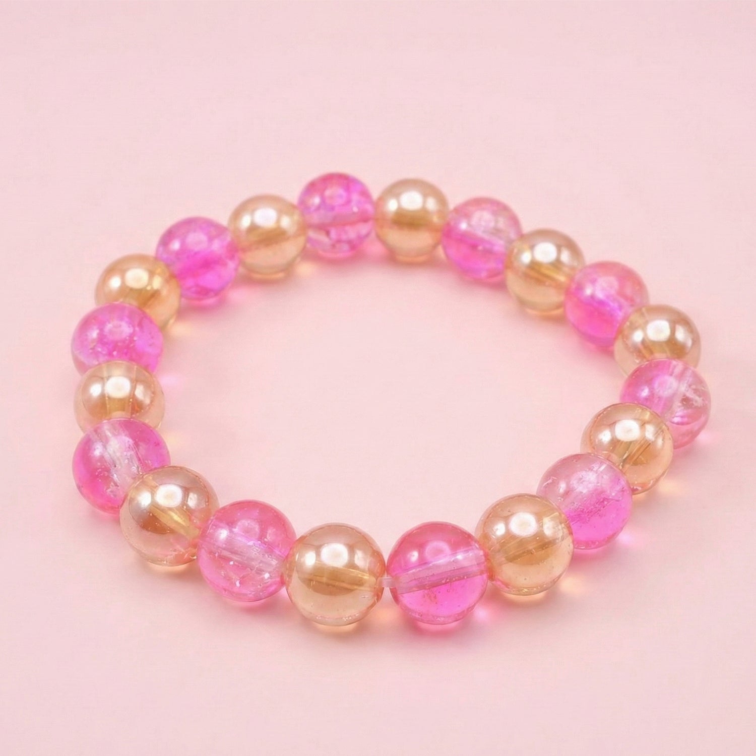 Fashion bracelet with transparent dual-tone beads in pink and gold