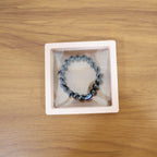 Lifestyle image of wrist wearing crystal beaded dual-tone stretch bracelet