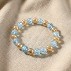 Close-up of glossy dual-tone beads on crystal stretch bracelet