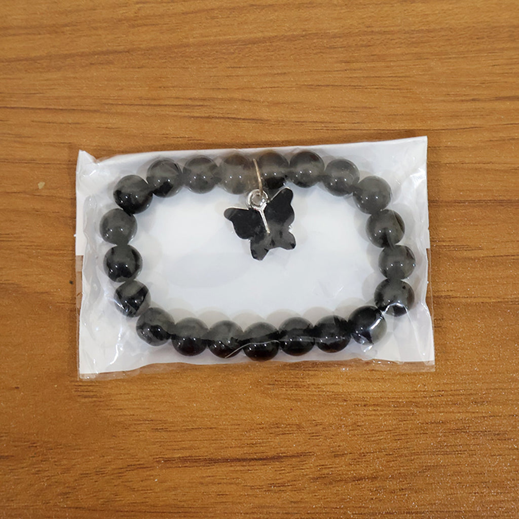 Styled display of beaded bracelet with elegant butterfly charm