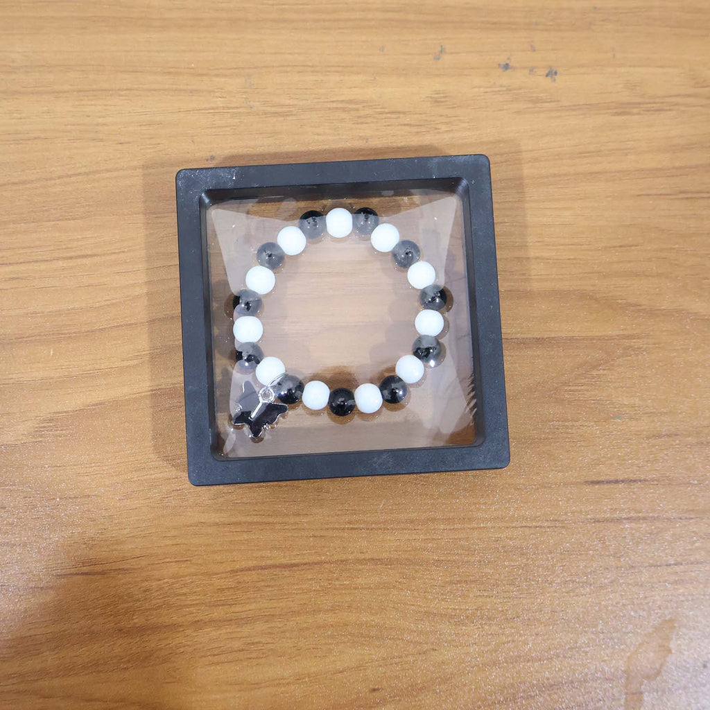 Elegant black and white beaded bracelet worn as fashion accessory