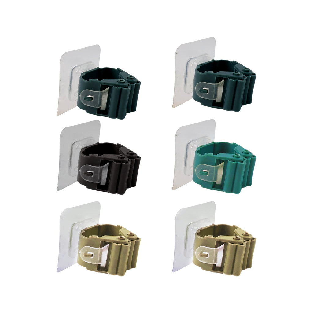 Self-adhesive cleaning tool clips mounted on a smooth wall surface