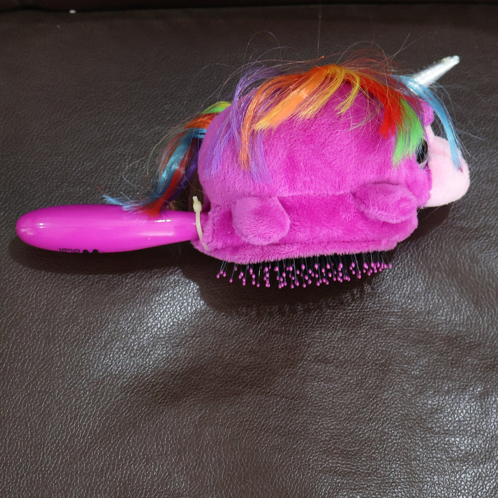 Young girl gently brushing her hair with the Kids Unicorn Detangling Brush