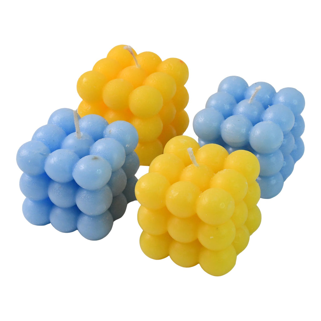 Multi-color cube wax candles glowing softly creating cozy atmosphere