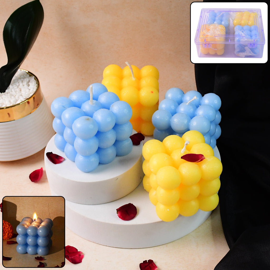 Set of colorful cube candles in blue and yellow with decorative spherical details