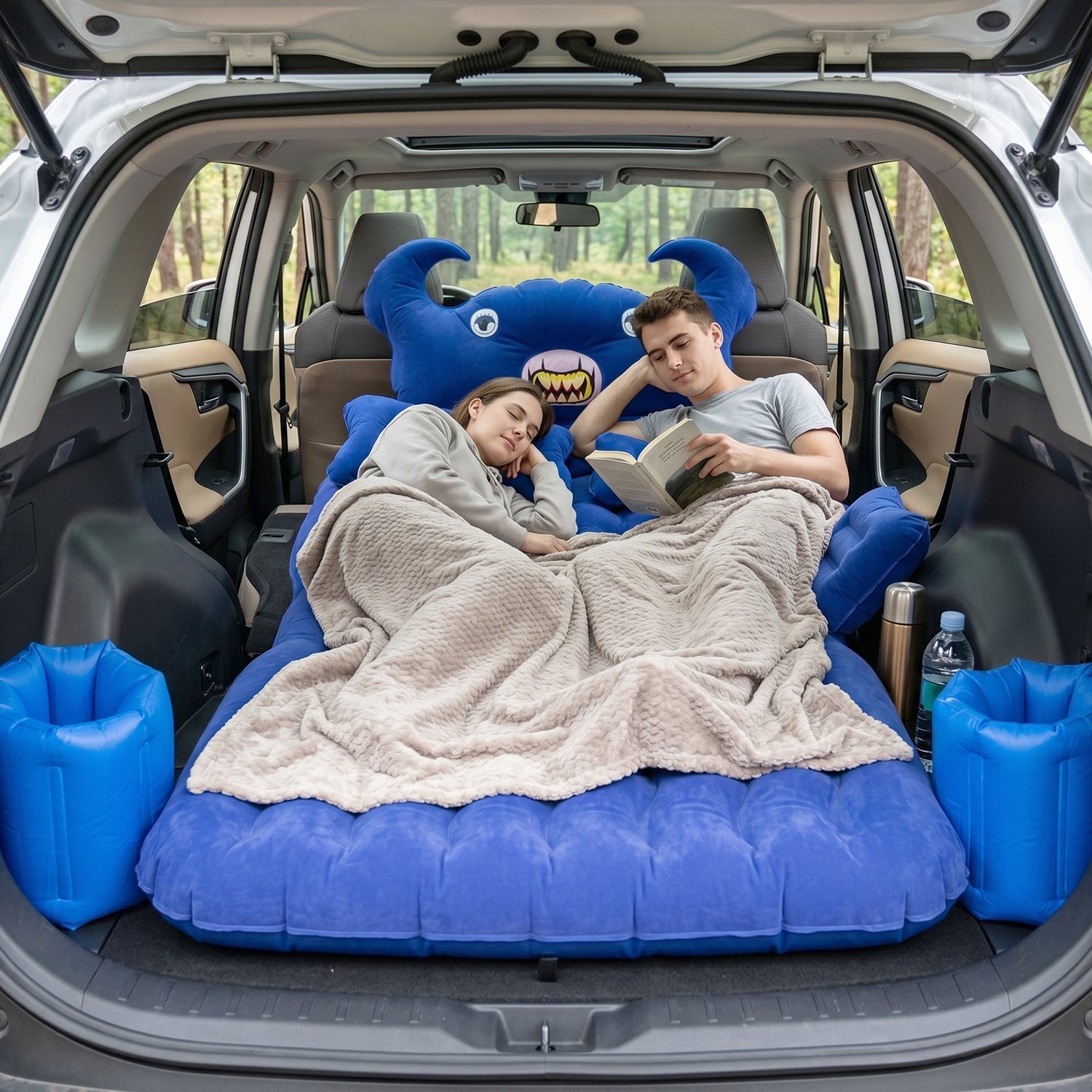 Vehicle interior with inflated inflatable car mattress and cushions