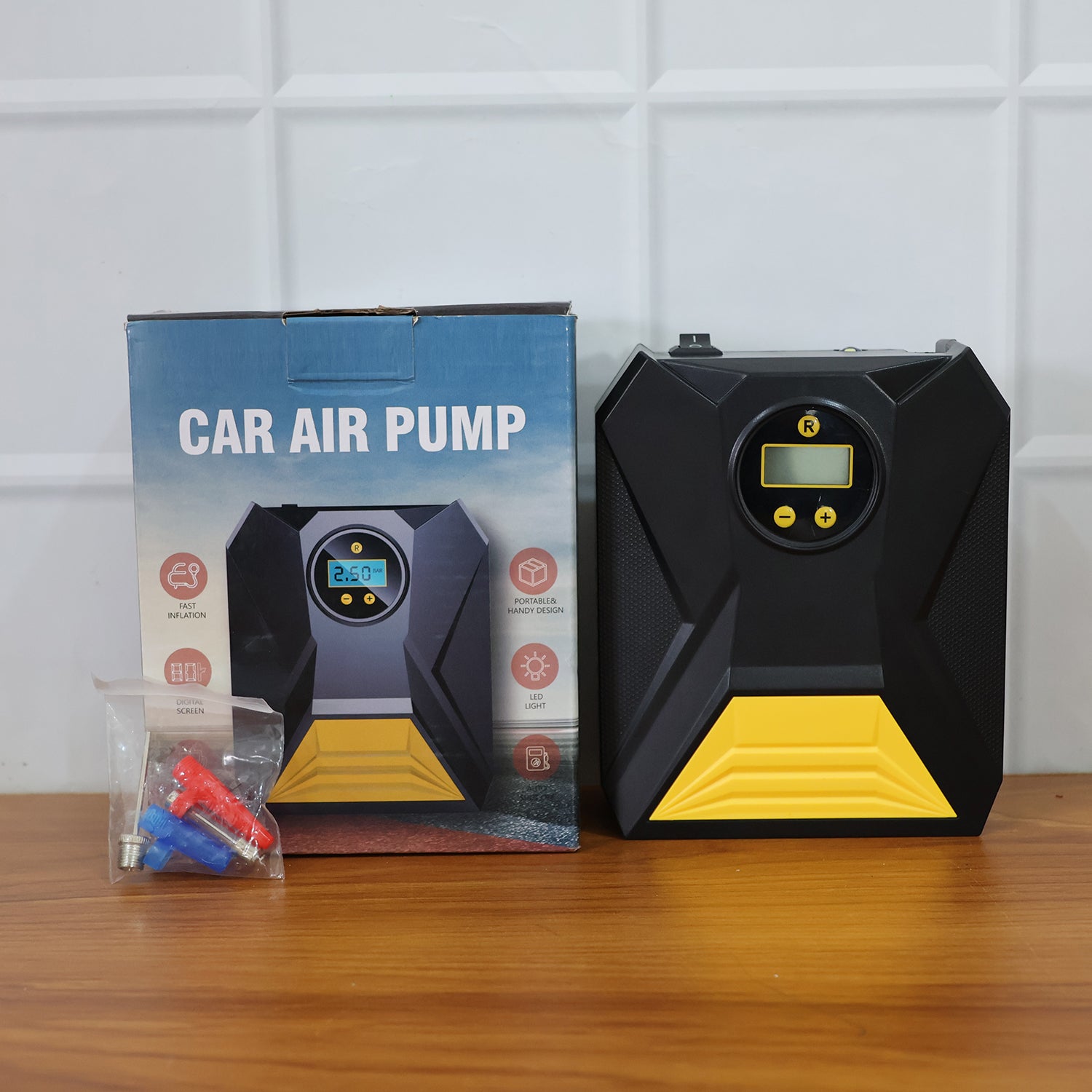Mini digital portable car tyre air compressor operating during inflation