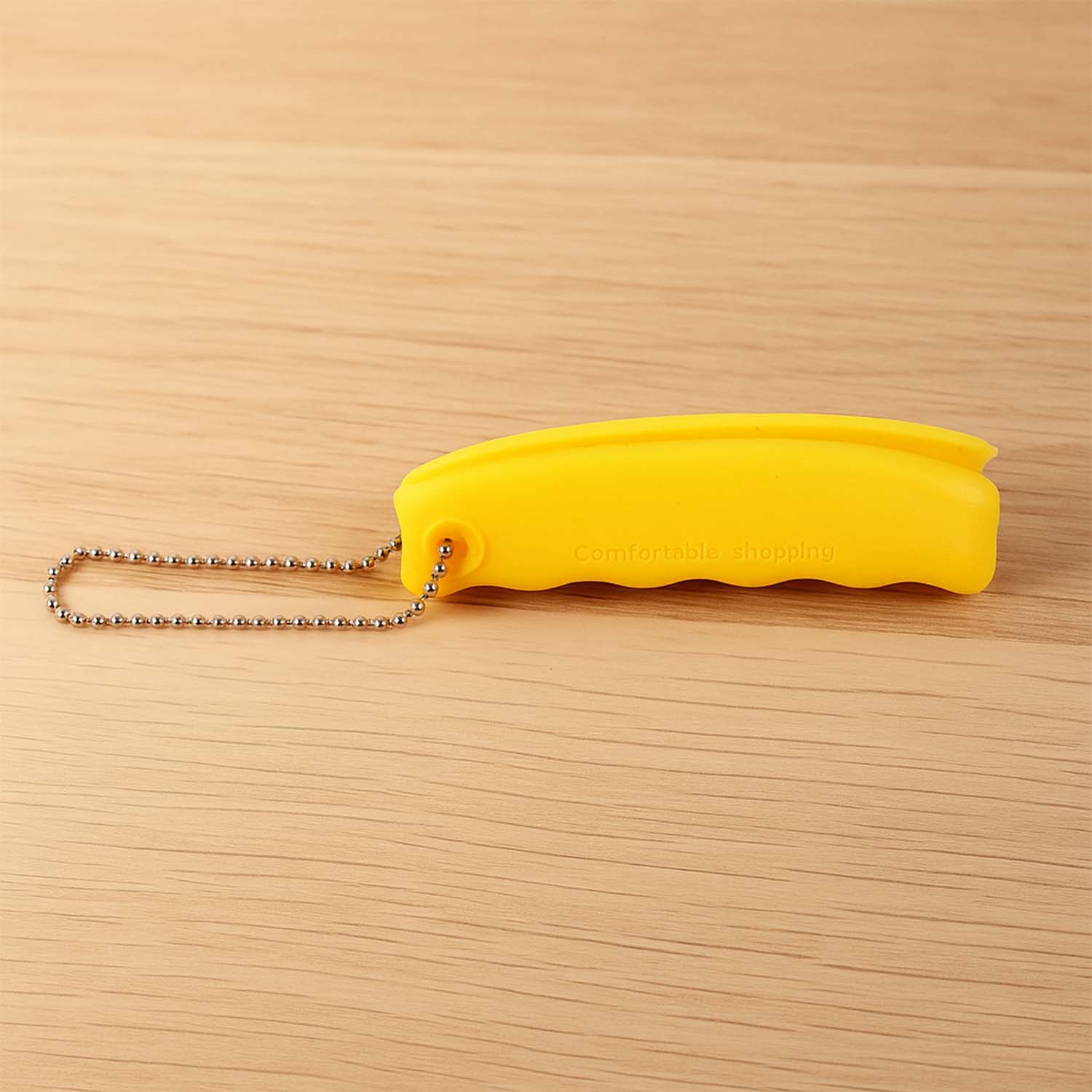 Compact Silicone Bag Carrier conveniently attached to a keyring for easy access.