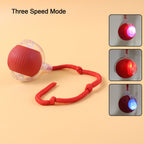LED light interactive cat toy ball with detachable braided tail on a clean surface