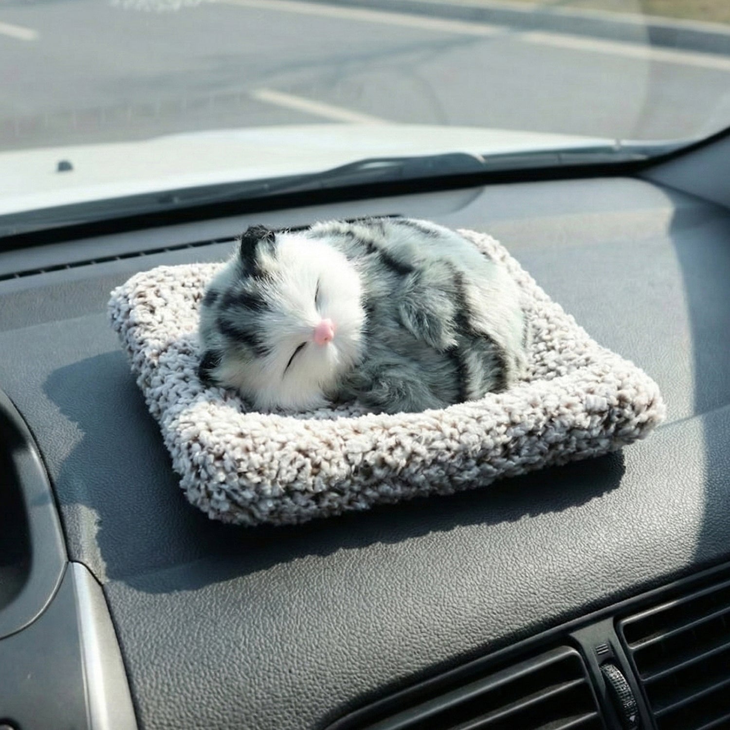 Adorable plush cat car ornament with a soft finish and closed eyes