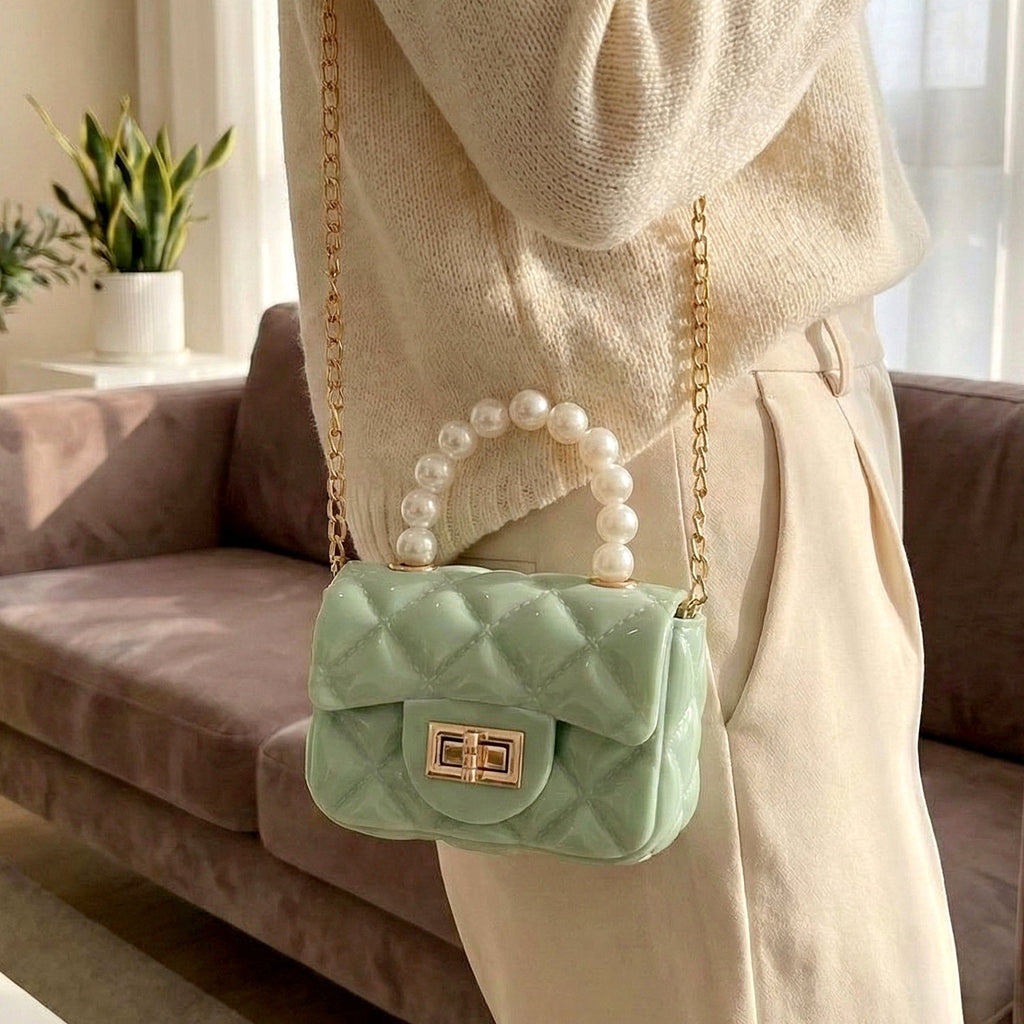 Quilted mini handbag featuring a detachable gold chain strap for versatile styling