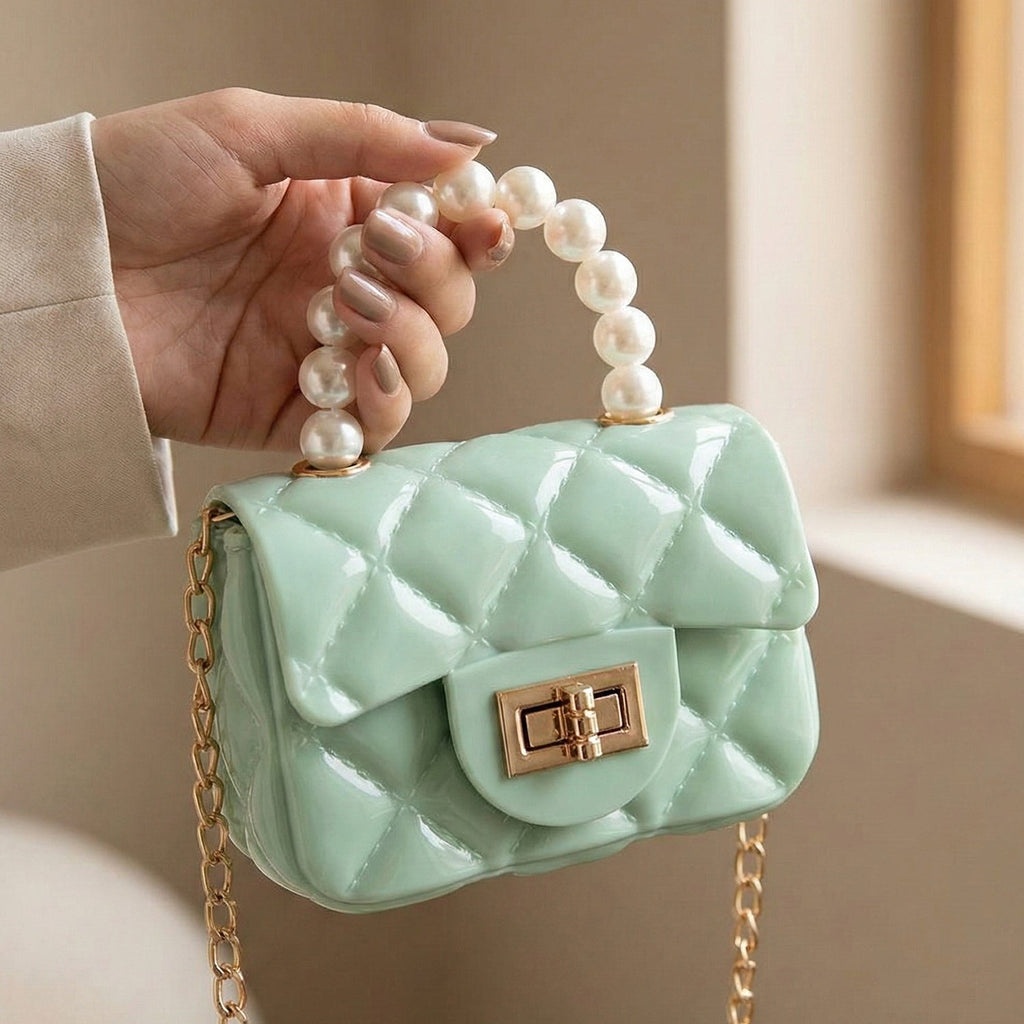 Elegant mini handbag with classic pearl handle and detailed quilted pattern