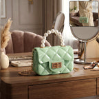 Quilted mini handbag showcasing elegant pearl handle and gold chain strap