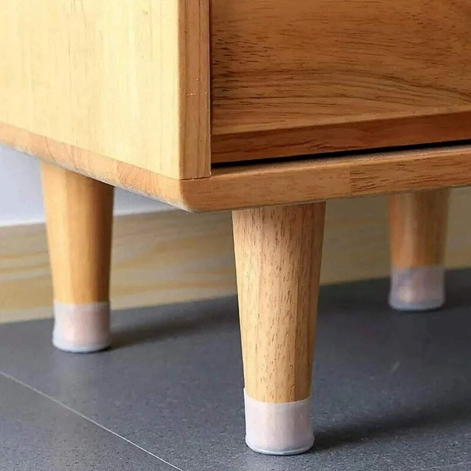 Silicone furniture pads fitted on chair legs for floor protection