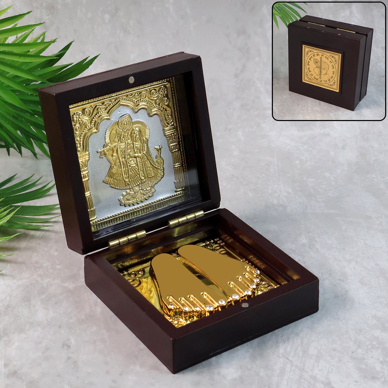 Elegant gold-finished Charan Paduka set displayed inside wooden box with Radha Krishna design