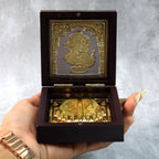 Video presenting golden Charan Paduka in wooden box used as devotional pooja accessory
